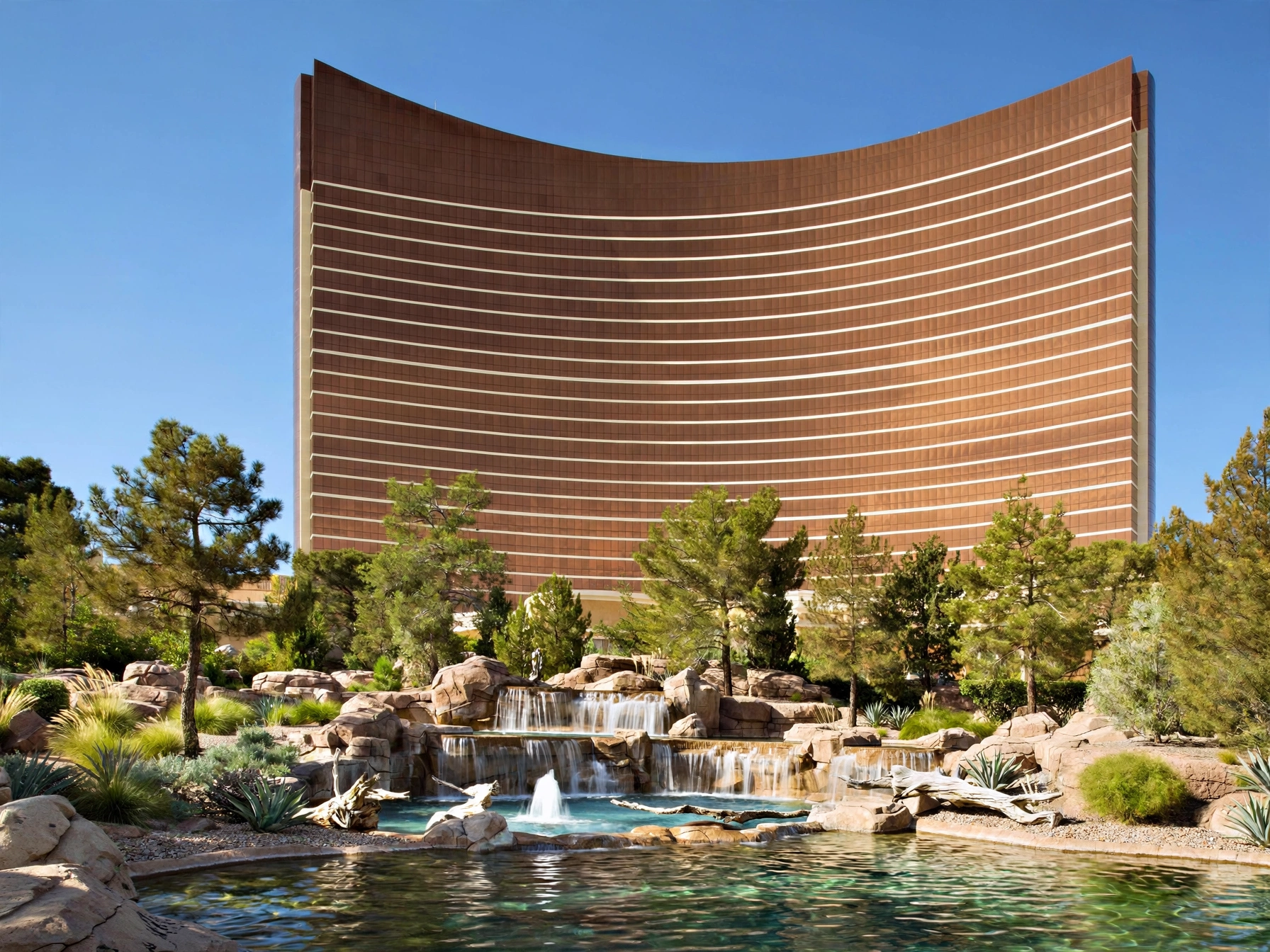 Curved bronze glass towers of Wynn Las Vegas against clear sky